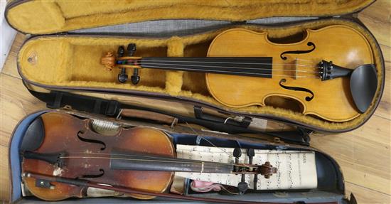 A cased violin and a three quarter size violin